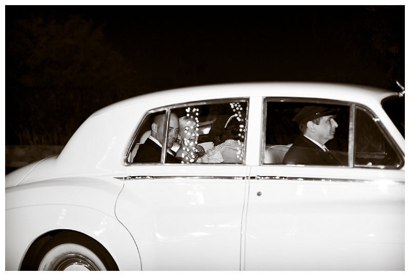 Bride and groom leaving in a car