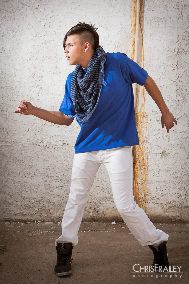 A young hip hop dancer popping a move