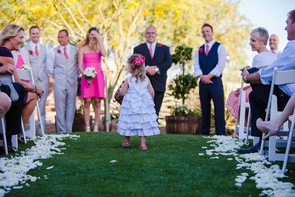 A beautiful flower girl walking up the aisle at a wedding.