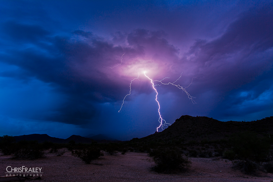 A lightning strike ionizes the air as it descends upon the Arizona desert.