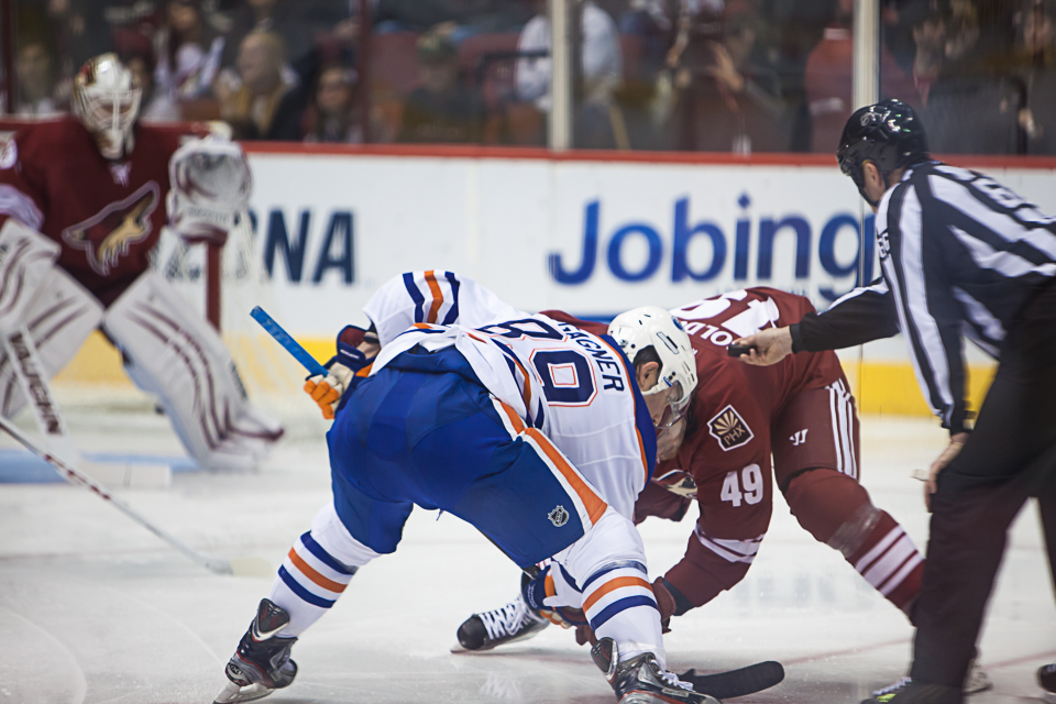 Coyotes and Oilers hockey player faceoff