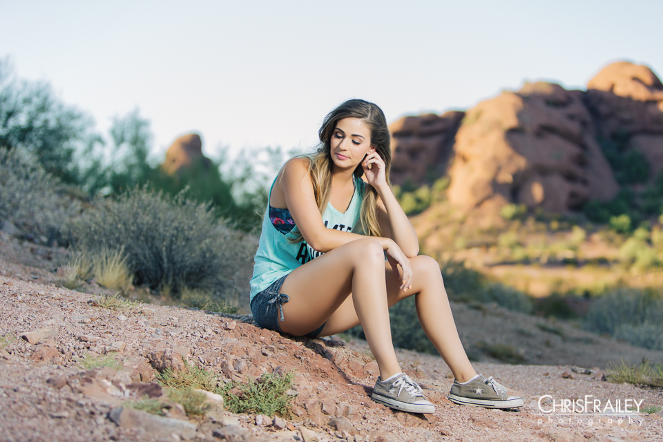 Model sitting on the red rocks of the Arizona desert.