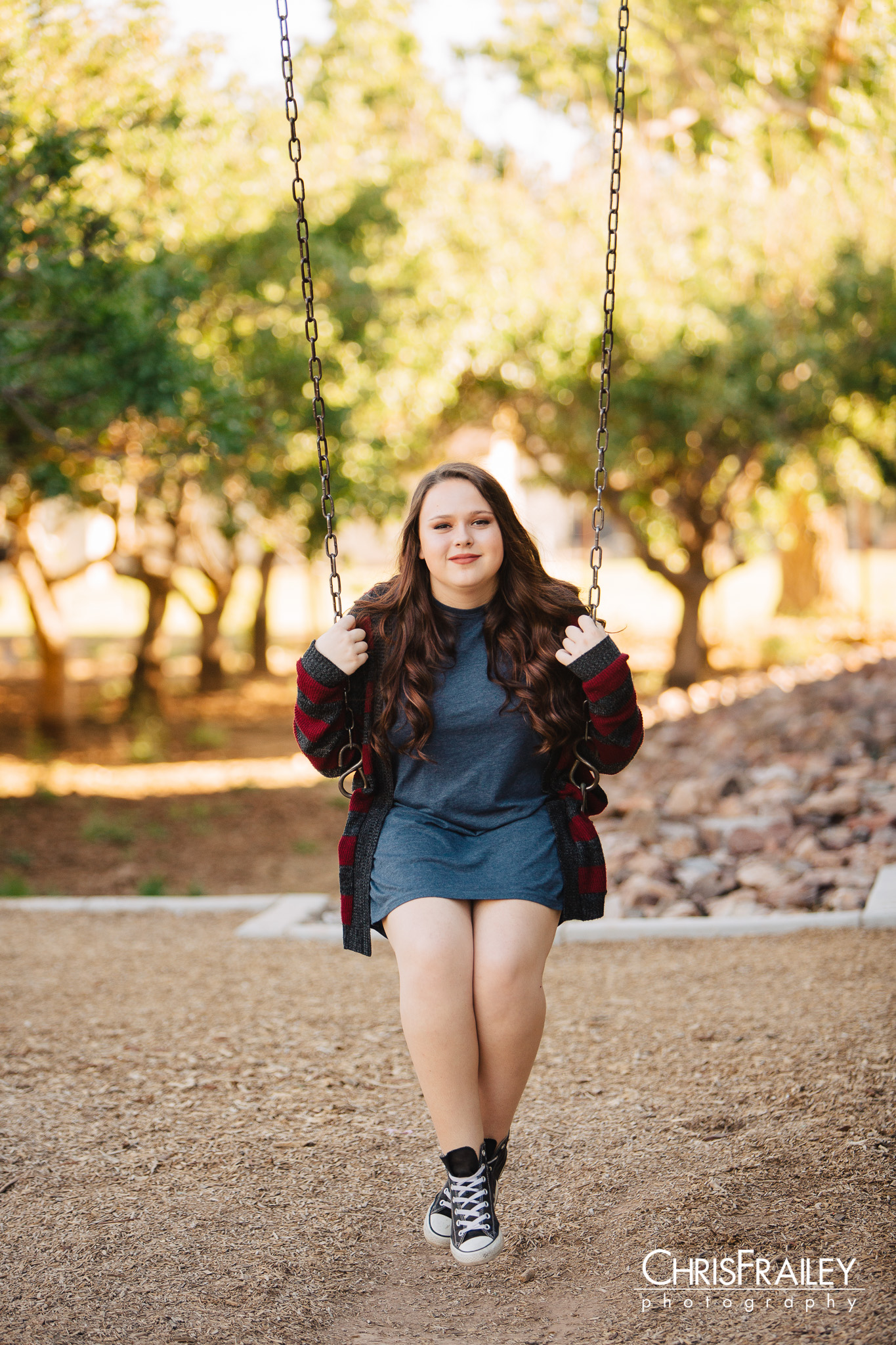 High school girl swinging on a swing. 