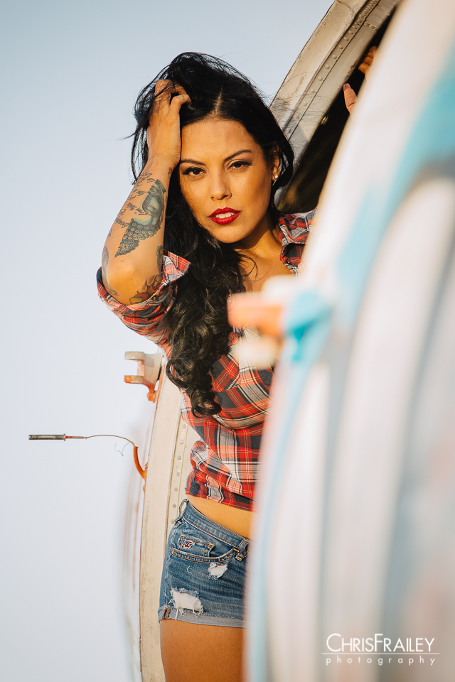 Pinup model posing on an old airplane