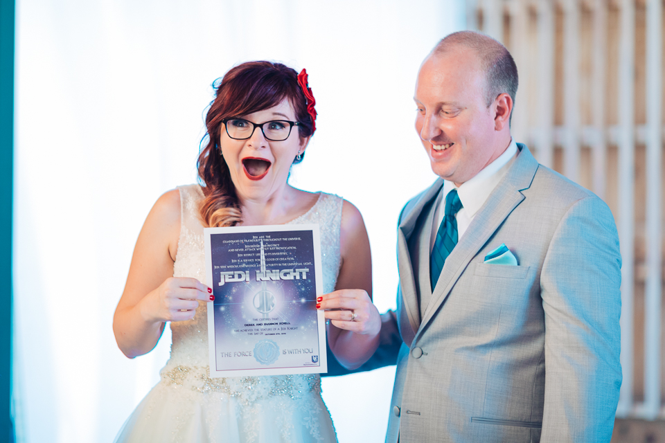 Bride holding a Star Wars marriage license.