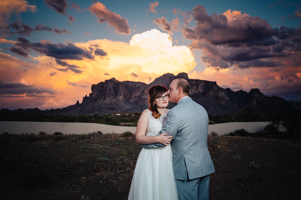 Bride and groom hugging during sunset.