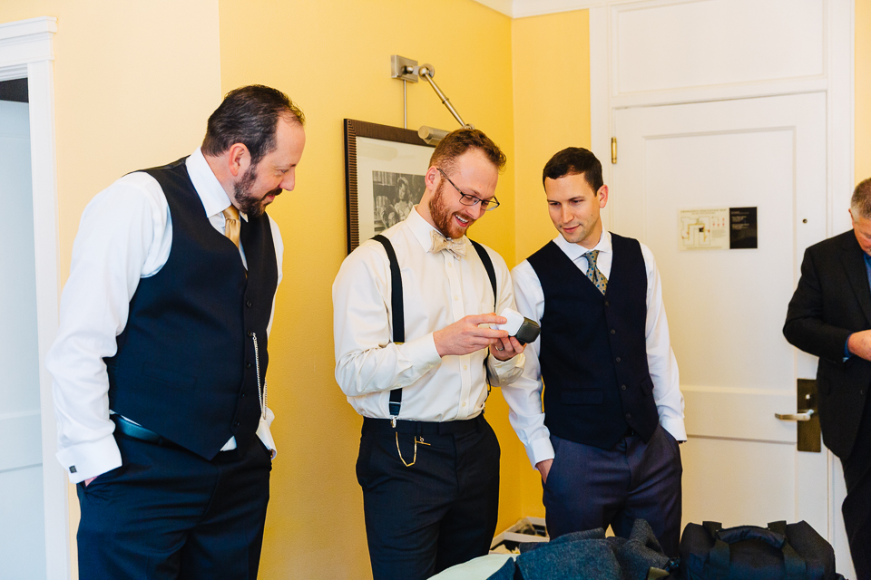 Groomsmen looking at gifts for a Portland wedding.