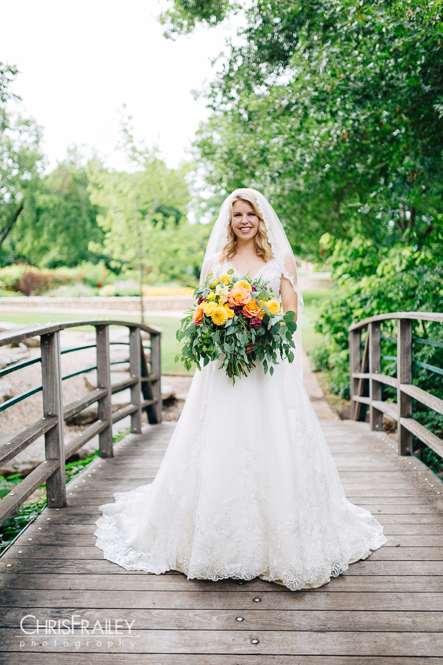 Bride posing on a wooden bridge at the Fort Worth Botanic Garden in Fort Worth Texas.