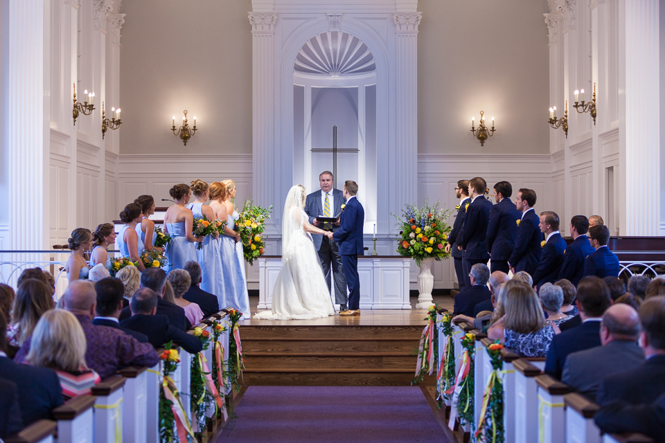 Bride and groom holding hands at alter of Robert Carr Chapel.
