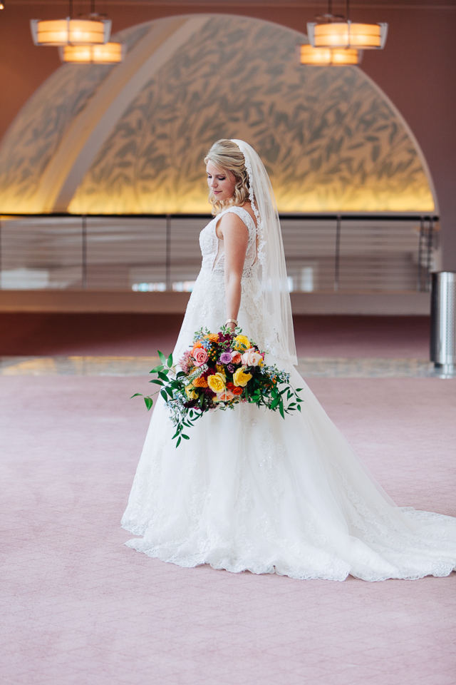 Bride posing with her bouquet at Bass Hall. 