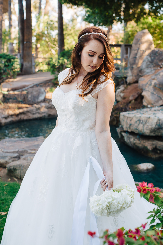 Bridal portrait with bride holding bouquet at fun filled Val Vista Lakes wedding. 
