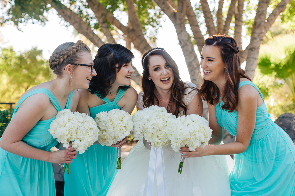 Bride laughing and smiling with her bridesmaids.