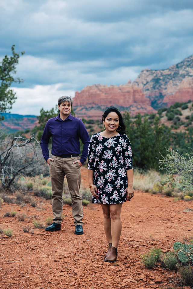Couple posing in front of red rocks of Sedona.