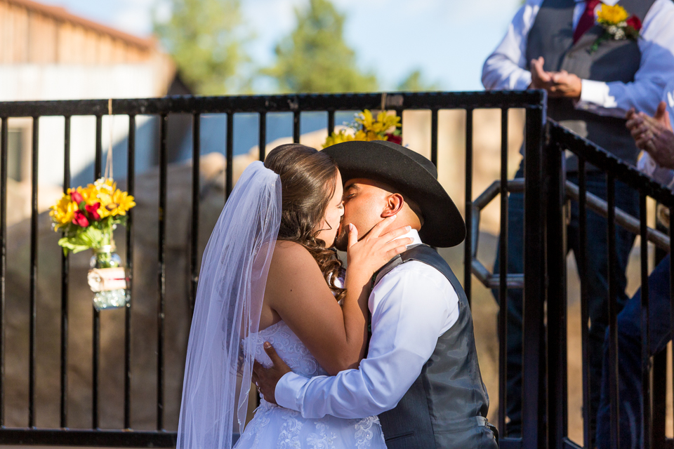 Bride and groom kissing during Bearizona wedding ceremony.