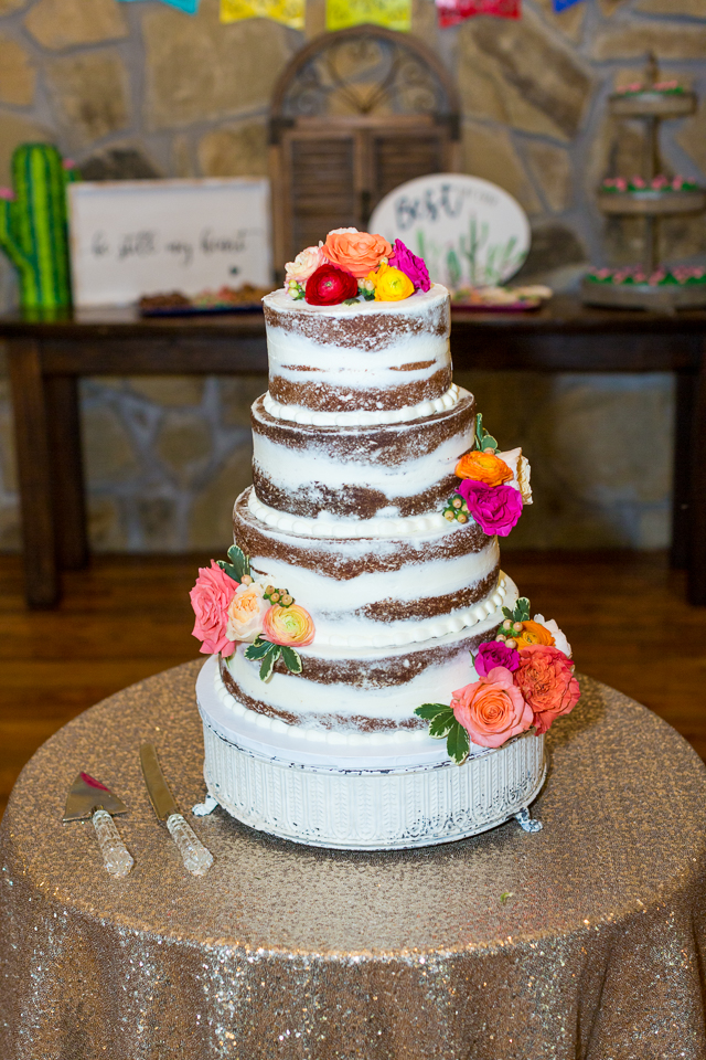 Naked wedding cake decorated with flowers.