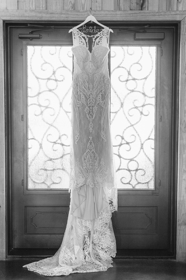 Wedding dress hanging in entryway.