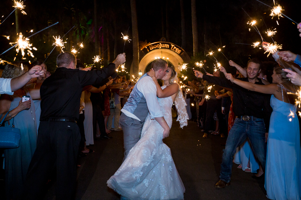 Groom dipping bride at a sparkler exit Boojum Tree wedding.