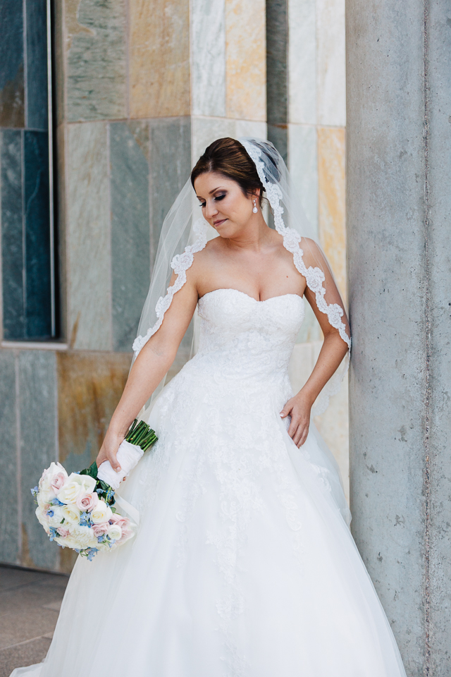 Bride standing with her bridal bouquet. 