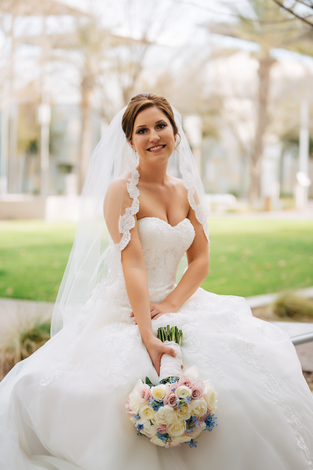 Bride sitting with her bouquet.