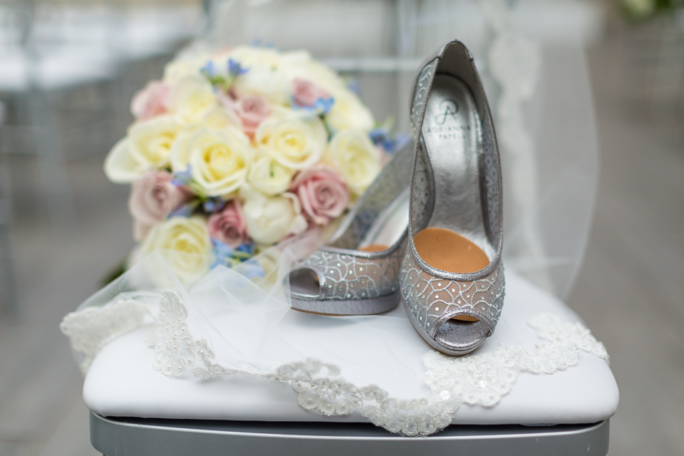 Bride's silver wedding shoes and her bouquet.
