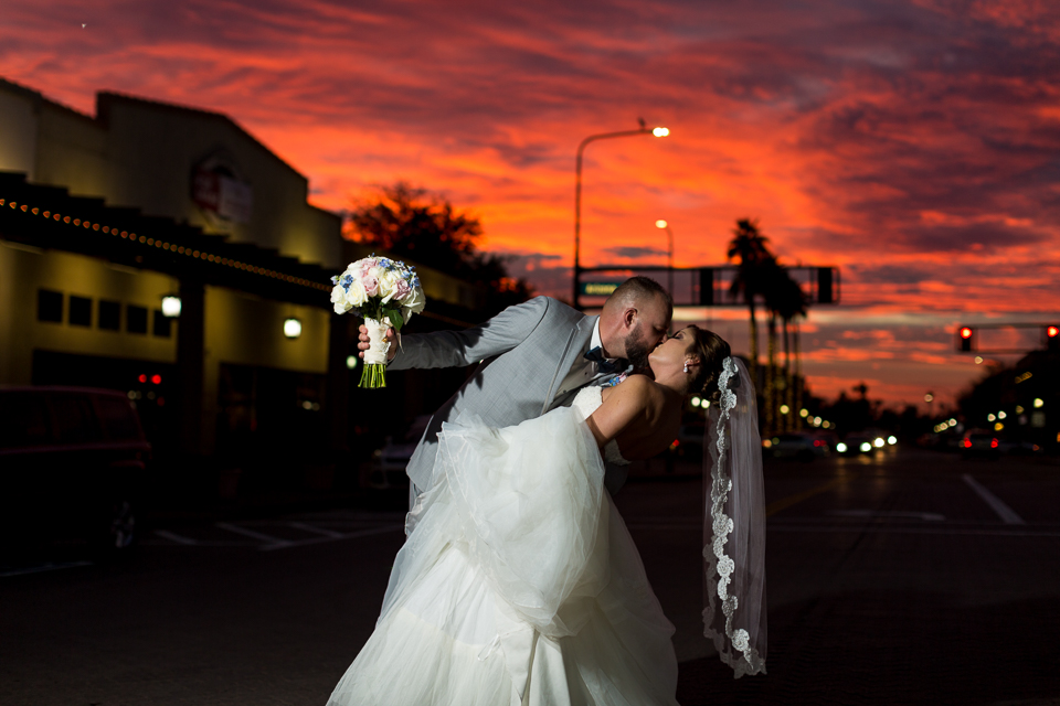 Groom dipping bride during an Arizona sunset.