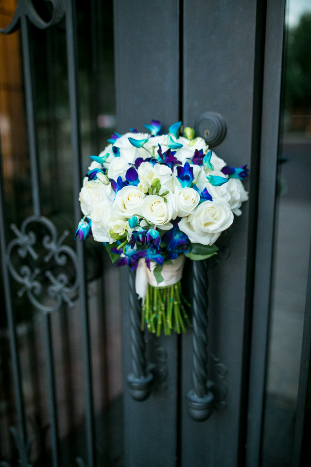 Brides bouquet placed in the handles of the iron gate at Villa Siena. 