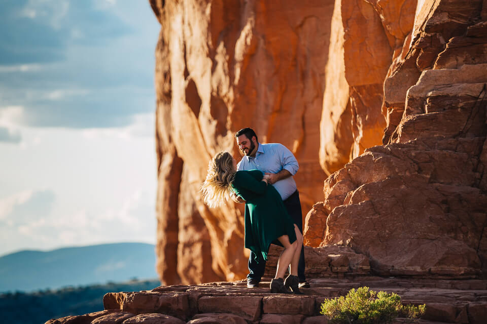 Engaged couple holding a dip pose at Cathedral Rock.