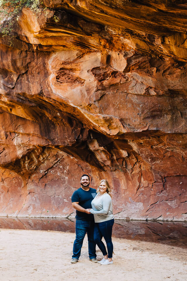 Engaged couple posing at West Fork Trail bend. 