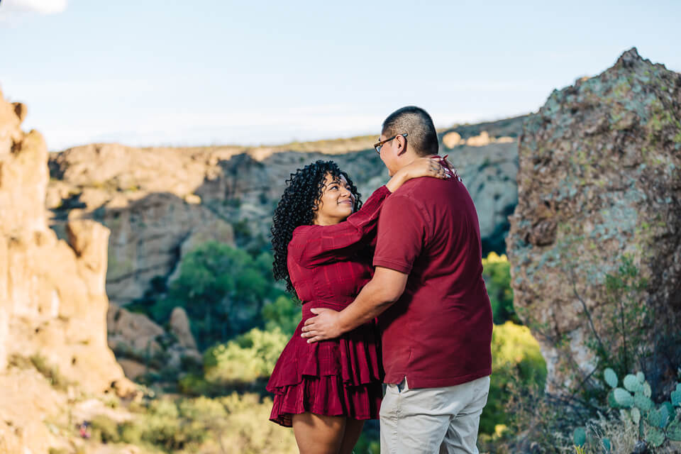 Couple embracing each other at Cactus Rock Boyce Thompson Arboretum.