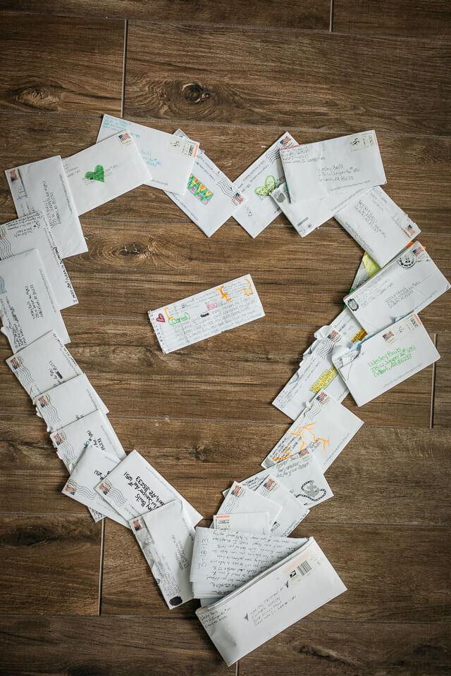 Love letters from groom to bride laid out in a heart shape.