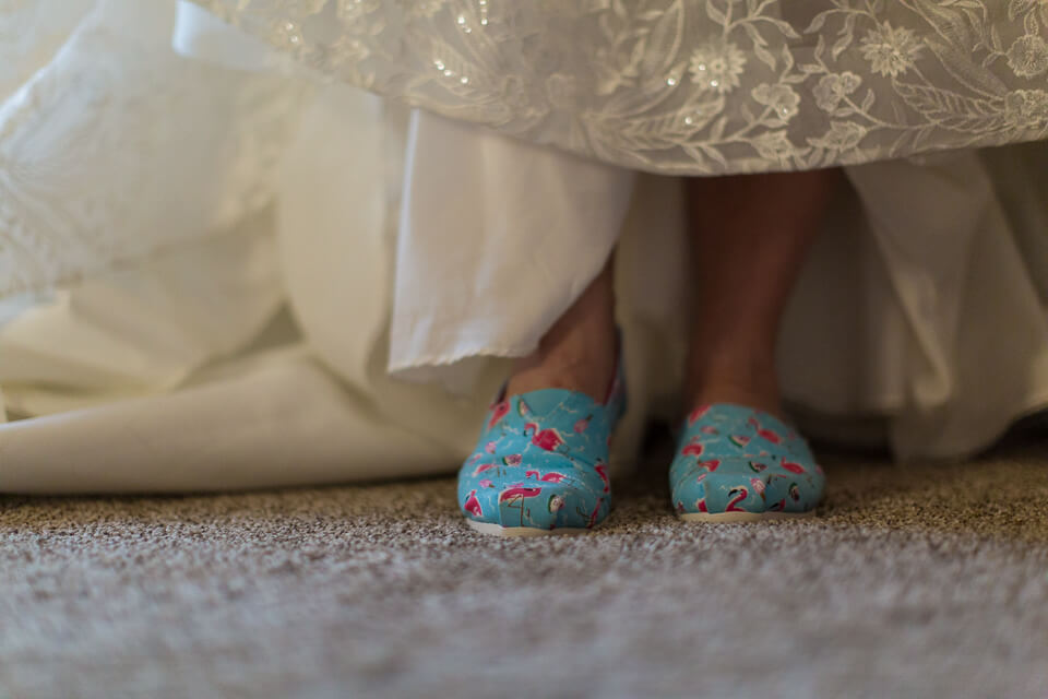 Bride's wedding shoes are Toms. 
