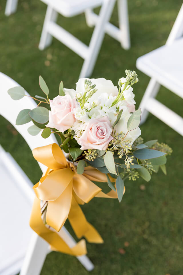 Flower on chair at ceremony