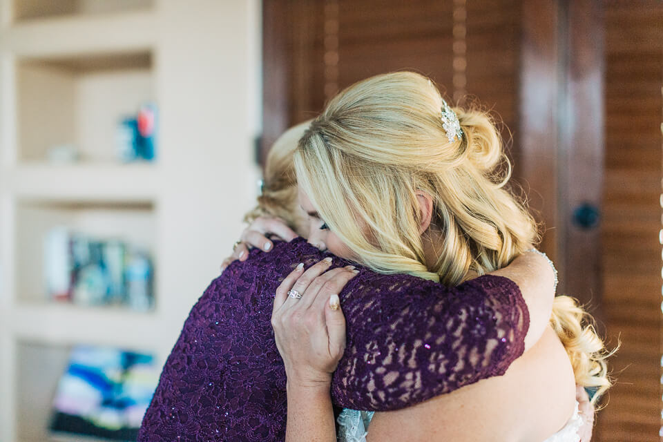 Mom and bride hugging. 