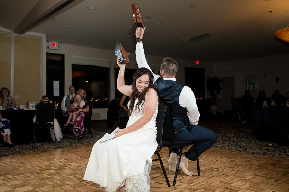 Bride and groom playing the shoe game at their wedding reception.