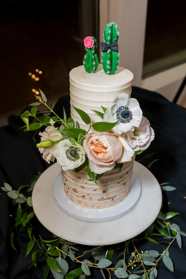 Wedding cake with cactus toppers. 