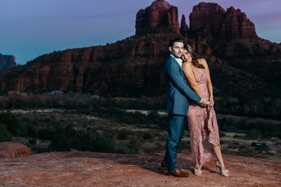 Couple holding each other closely for their Sedona engagement photos. 