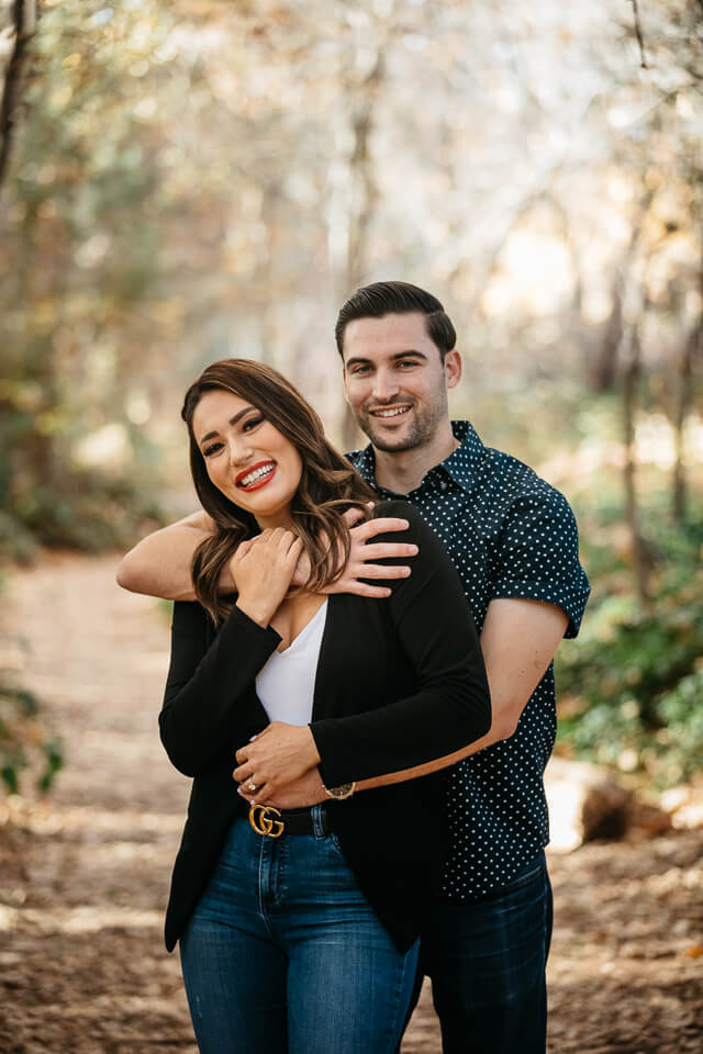 Guy holding his fiancé from behind during their Sedona engagement photos.