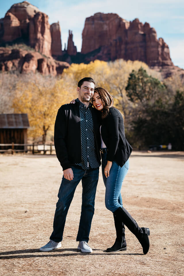 Engaged couple posing in front of a water wheel at Red Rock Crossing Sedona Arizona. 