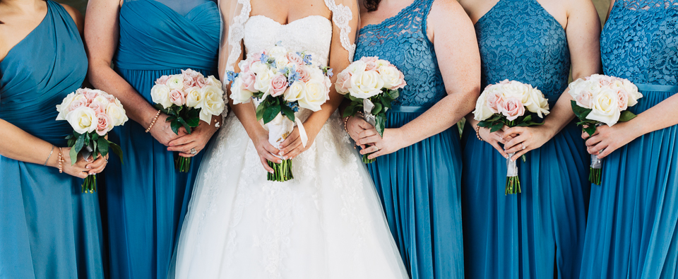 Bride and bridesmaids holding their bouquets.
