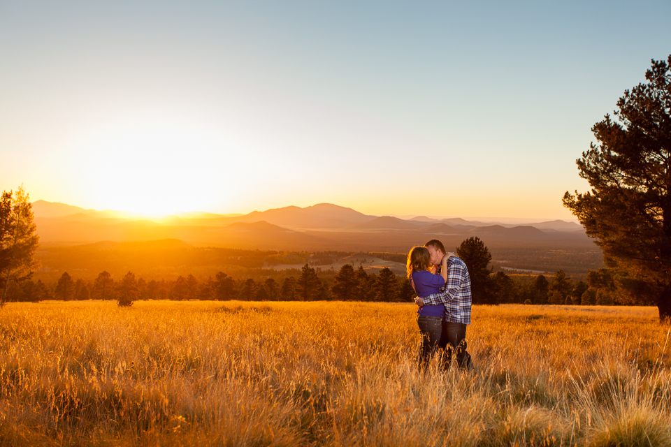 Couple standing in a field at sunset near Humphrey's Peak.