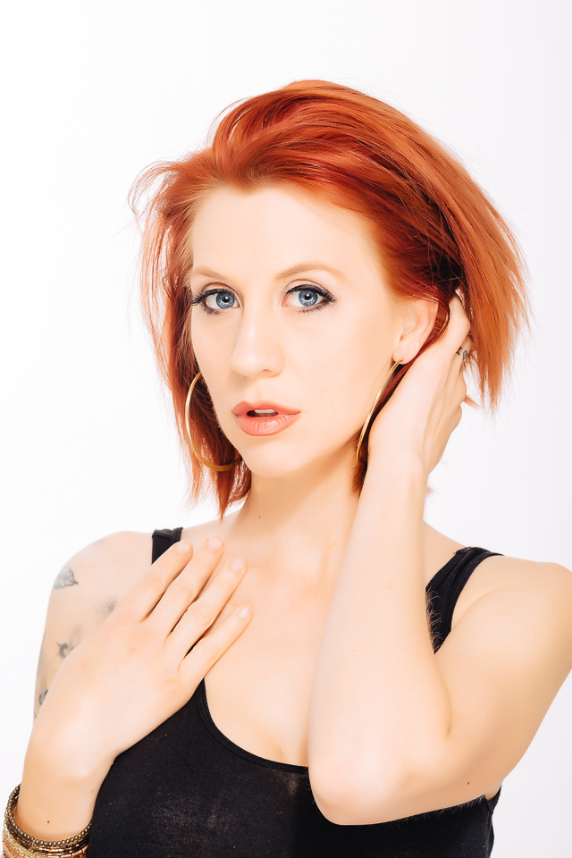 Red head model posing for a headshot.