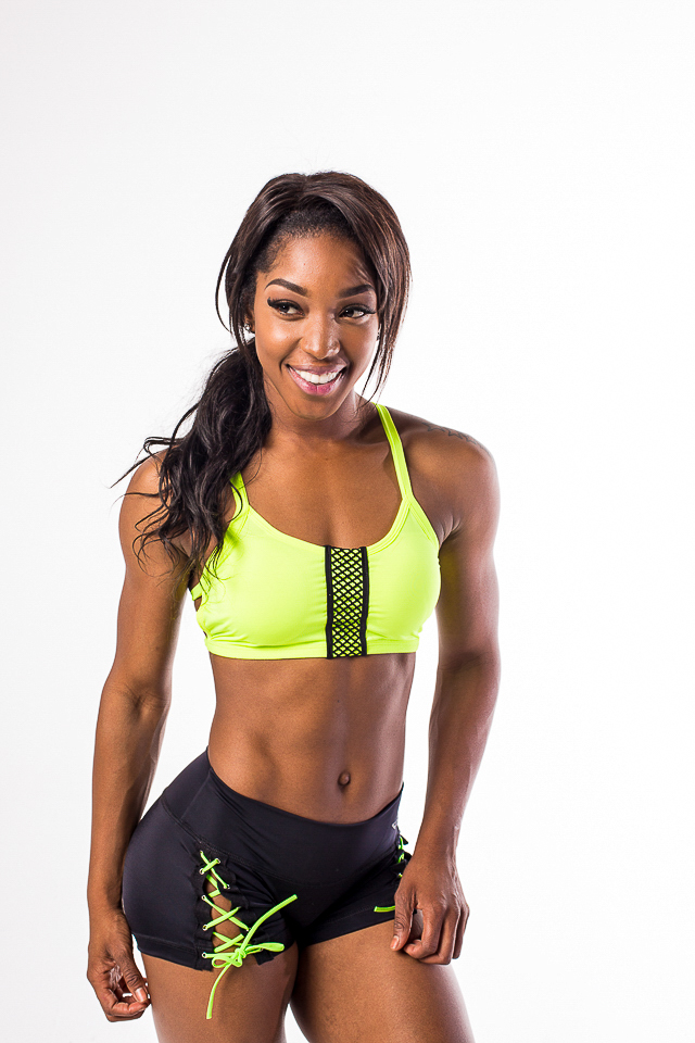 Young female fitness athlete posing in studio.