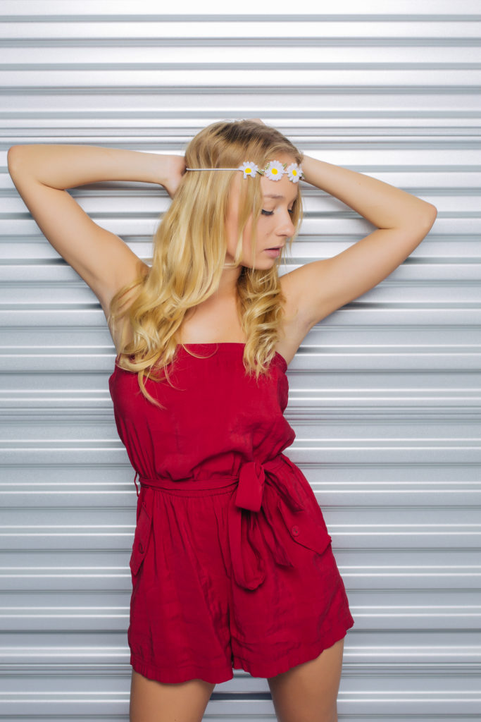 Female model posing in a red dress.